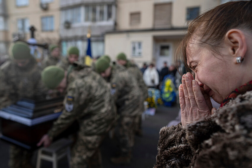 A woman cries during a funeral ceremony of Volodymyr Golubnychyi, Ukrainian senior lieutenant of 72nd Mechanized Brigade, in Kyiv, Ukraine, on Wednesday, Feb. 28, 2024. Golubnychyi was killed during the fighting with Russian forces in Vodyane village, Avdiivka direction, on Feb. 19. (AP Photo/Evgeniy Maloletka)