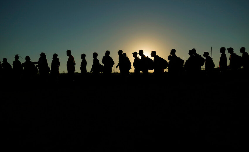 Migrants who crossed the Rio Grande and entered the U.S. from Mexico are lined up for processing by U.S. Customs and Border Protection, Sept. 23, 2023, in Eagle Pass, Texas. (AP Photo/Eric Gay, File)