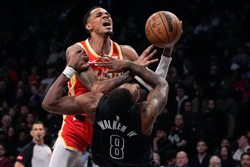 Brooklyn Nets' Lonnie Walker IV (8) fouls Atlanta Hawks' Dejounte Murray during the first half Thursday, Feb. 29, 2024, in New York. (AP Photo/Frank Franklin II)