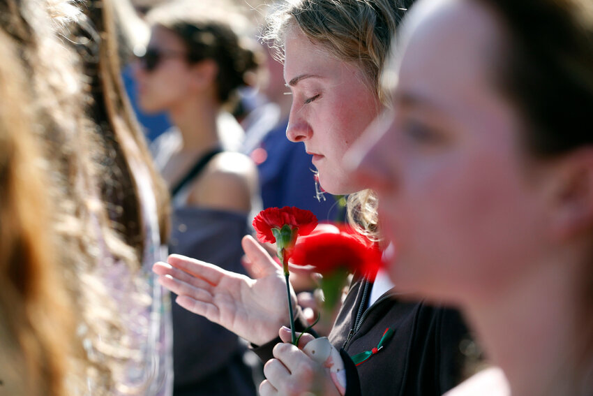 People gather to mourn the loss of Laken Riley during a vigil for the Augusta University College of Nursing student at the Tate Plaza on the University of Georgia campus in Athens, Ga., Monday, Feb. 26, 2024. (Joshua L. Jones/Athens Banner-Herald via AP, File)