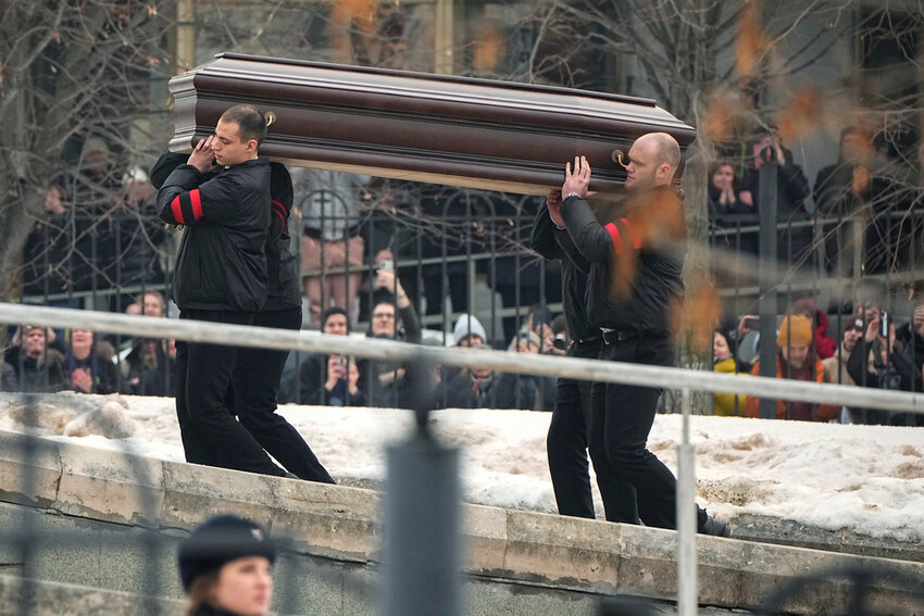 Workers carry the coffin of Russian opposition leader Alexei Navalny to the Church of the Icon of the Mother of God Soothe My Sorrows, in Moscow, Friday, March 1, 2024. (AP Photo)