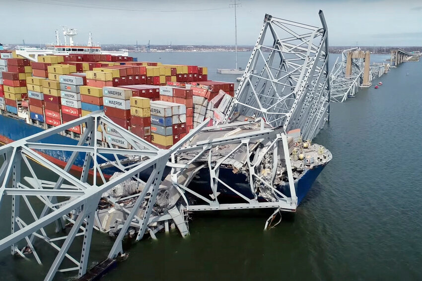 The cargo ship Dali is stuck under part of the structure of the Francis Scott Key Bridge after the ship hit the bridge Tuesday, March 26, 2024, in Baltimore. (NTSB via AP)