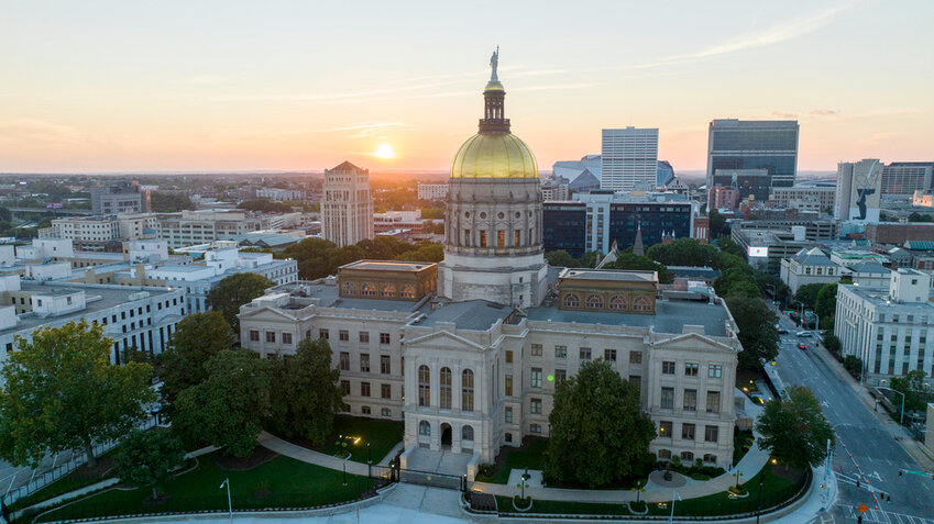 The sun sets behind the gold dome of the Georgia State Capitol in Atlanta, Aug. 28, 2022. (AP Photo/Steve Helber, File)