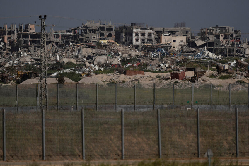 Destroyed buildings stand in the Gaza Strip as seen from southern Israel, Thursday, March 28, 2024. (AP Photo/Leo Correa)