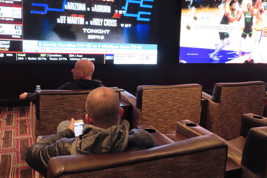 NCAA basketball tournament brackets are displayed on video screens at a  casino in Atlantic City N.J. on Wednesday, March 21, 2024. (AP Photo/Wayne Parry)