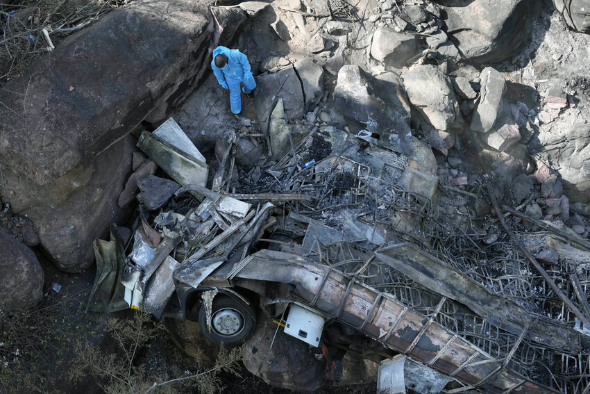 The wreckage of a bus lays in a ravine a day after it plunged off a bridge on the Mmamatlakala mountain pass in South Africa, Friday, March 29, 2024. (AP Photo/Themba Hadebe)