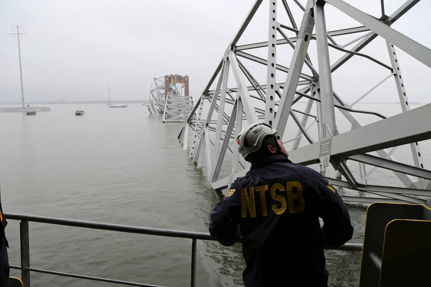 A National Transportation and Safety Board investigator is seen on the cargo vessel Dali, which struck and collapsed the Francis Scott Key Bridge, Wednesday, March 27, 2024 in Baltimore. (Peter Knudson/NTSB via AP)