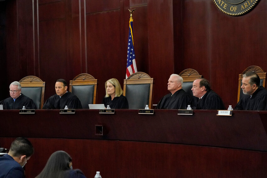 Arizona Supreme Court Justices from left; William G. Montgomery, John R Lopez IV, Vice Chief Justice Ann A. Scott Timmer, Chief Justice Robert M. Brutinel, Clint Bolick and James Beene listen to oral arguments on April 20, 2021, in Phoenix.(AP Photo/Matt York, File)