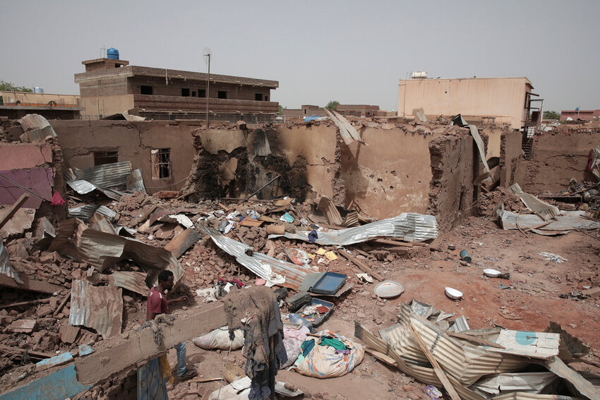 A man walks by a house destroyed in recent fighting in Khartoum, Sudan, April 25, 2023. (AP Photo/Marwan Ali, File)