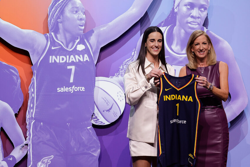 Iowa's Caitlin Clark, left, poses for a photo with WNBA commissioner Cathy Engelbert, right, after being selected first overall by the Indiana Fever during the first round of the WNBA draft, Monday, April 15, 2024, in New York. (AP Photo/Adam Hunger)