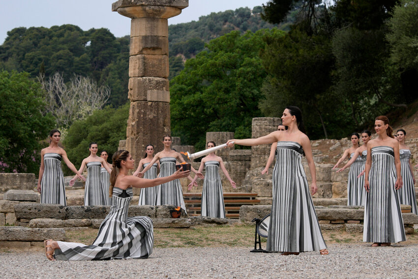 Performers take part in the official ceremony of the flame lighting for the Paris Olympics, at the Ancient Olympia site, Greece, Tuesday, April 16, 2024. (AP Photo/Thanassis Stavrakis)