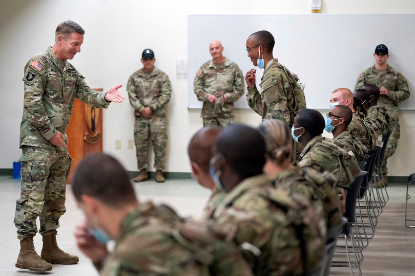 Chief of Staff of the Army Gen. James McConville, left, gestures to a student in the new Army prep course at Fort Jackson, S.C., Aug. 26, 2022. (AP Photo/Sean Rayford, File)