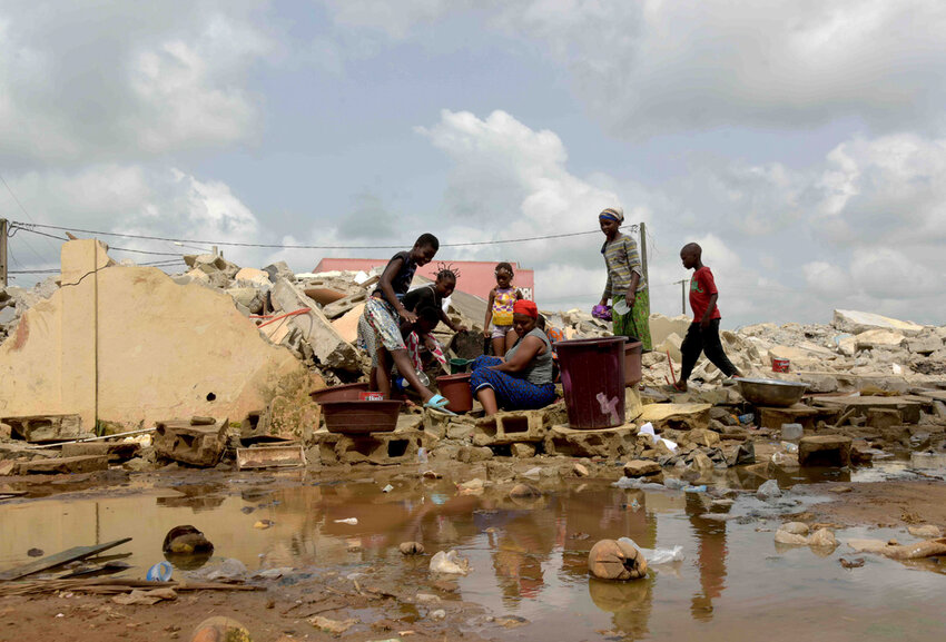 People whose houses were demolished on public health grounds collect water in the Gesco neighborhood of Abidjan, Ivory Coast, Wednesday, Feb. 28, 2024.(AP Photo/Diomande Ble Blonde)