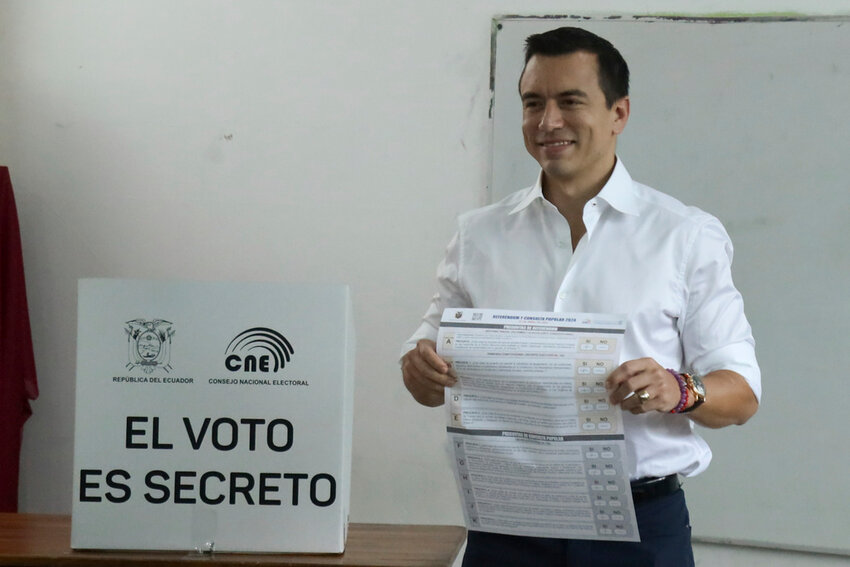 President Daniel Noboa holds the ballot during a referendum to endorse new security measures to crackdown on criminal gangs responsible for increasing violence, in Olon, Ecuador, Sunday, April 21, 2024. (AP Photo/Cesar Munoz)