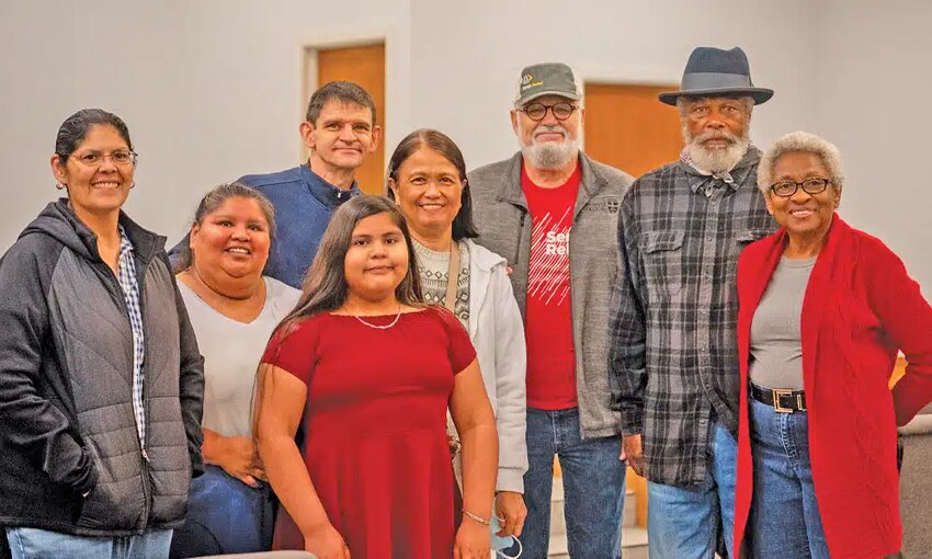Destiny, front in red dress, and her mother, Yvonne, second from left, represent two of the four generations of the same family baptized by Bobby Worthington, third from right. Other church members are also pictured. (Photo/Lake June Baptist Church via Southern Baptist Texan)