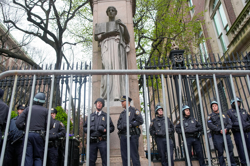 New York City police in riot gear stand guard outside the Columbia University campus after clearing the campus of protesters, April 18, 2024, in New York. (AP Photo/Mary Altaffer, file)