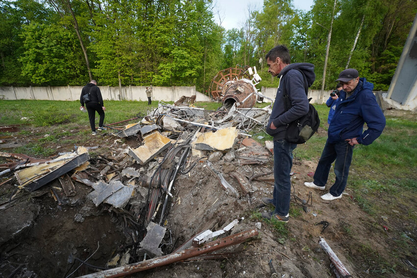 People look at fragments of the television tower which was destroyed in a Russian missile attack in Kharkiv, Ukraine, Monday, April 22, 2024. (AP Photo/Andrii Marienko)