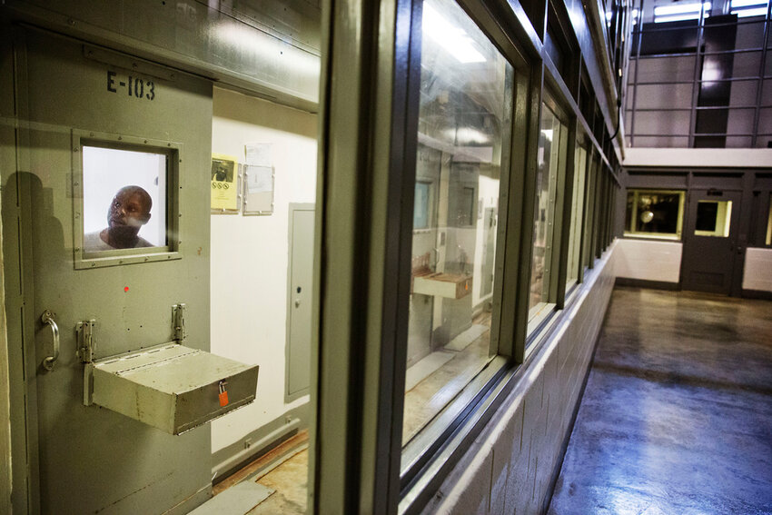 An inmate looks out of his cell in the Special Management Unit at the Georgia Diagnostic and Classification Prison, Dec. 1, 2015, in Jackson, Ga. (AP Photo/David Goldman, File)