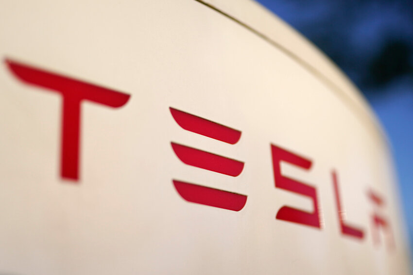 The logo for the Tesla Supercharger station is seen in Buford, Ga, April 22, 2021. (AP Photo/Chris Carlson, File)