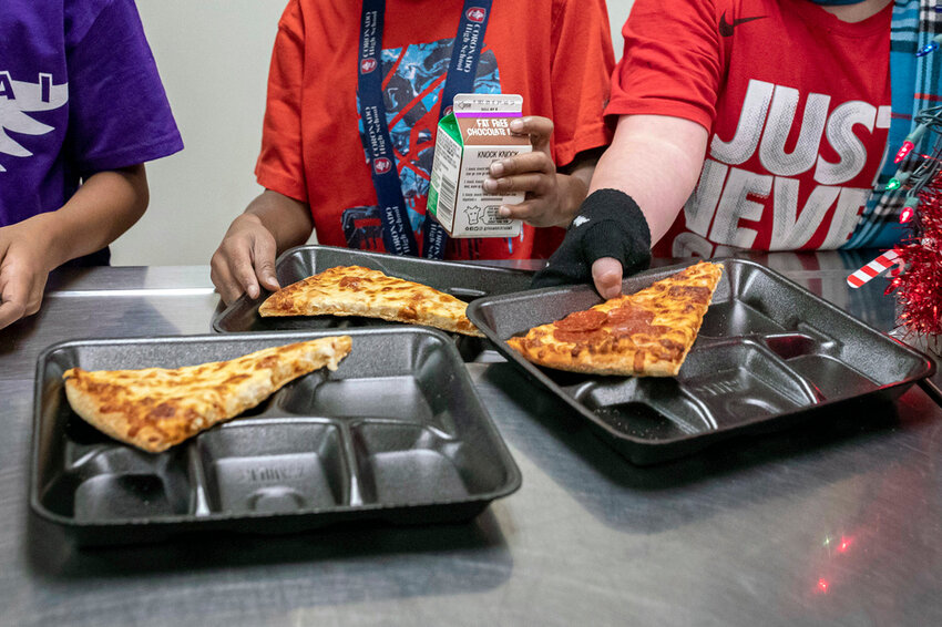 Second-grade students select their meals during their lunch break in the cafeteria, Dec. 12, 2022, at an elementary school in Scottsdale, Ariz. (AP Photo/Alberto Mariani, File)
