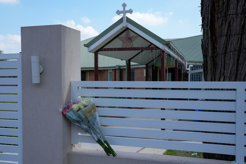 Flowers sit on a fence outside the Christ the Good Shepherd church in suburban Wakely in western Sydney, Australia, on April 16, 2024. (AP Photo/Mark Baker, File)