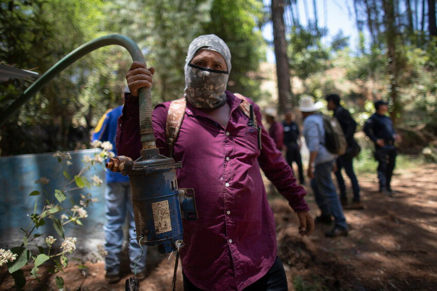 A man shows a pump removed from an unlicensed water intake as his group of residents, farmworkers and small-scale farmers from Villa Madero dismantle illegal water taps in the mountains of Villa Madero, Mexico, Wednesday, April 17, 2024. (AP Photo/Armando Solis)