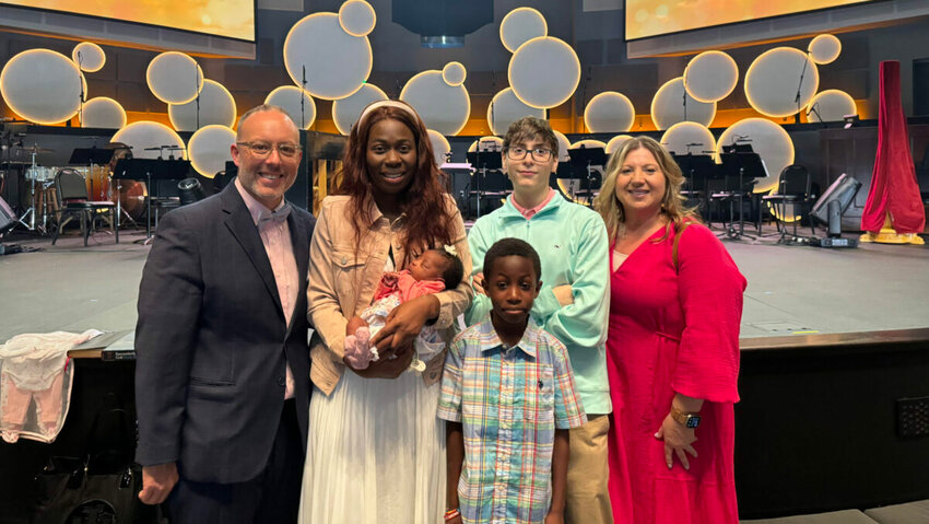 Hannah and her two children, Melissa and Daniel, stand beside Richie and Melissa Howard and their son, Jaxson. (Photo/Richie Howard via The Baptist Paper)