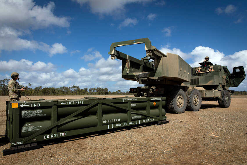 U.S. Army Sgt. Ian Ketterling, gunner for Alpha Battery, 1st Battalion, 3rd Field Artillery Regiment, 17th Field Artillery Brigade, prepares the crane for loading the Army Tactical Missile System onto the High Mobility Artillery Rocket System in Queensland, Australia, July 26, 2023. (Sgt. 1st Class Andrew Dickson/U.S. Army via AP)