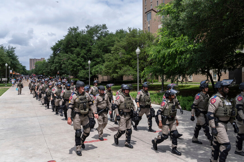Texas state troopers march down Speedway during a protest at the University of Texas, Wednesday, April 24, 2024, in Austin, Texas. (Mikala Compton/Austin American-Statesman via AP)