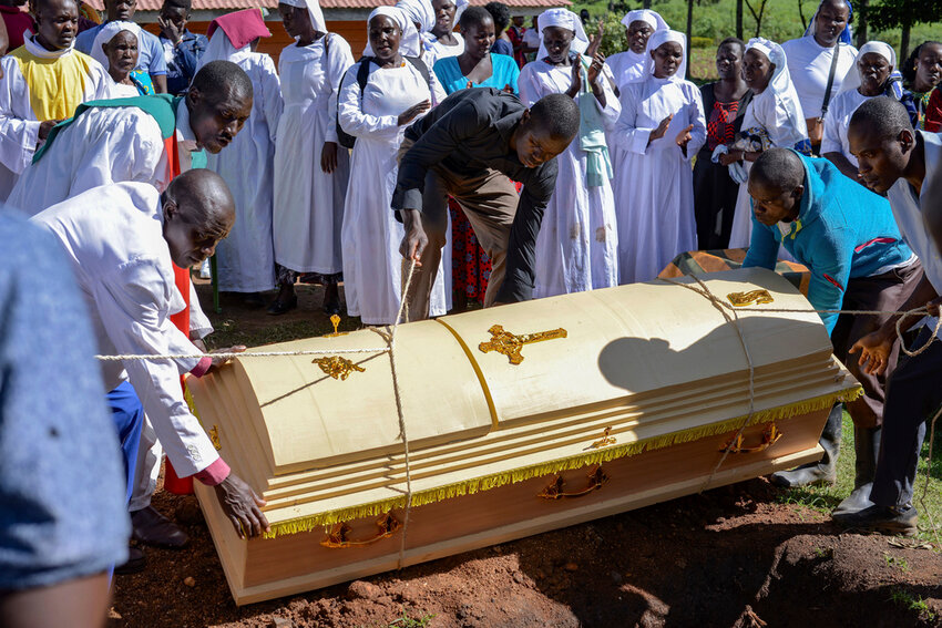 Friends and family lower the casket of Rose Bella Awuor after a funeral service at her home in Awendo, Migori County, Kenya, Thursday, April. 11, 2024. (AP Photo/Brian Ongoro)