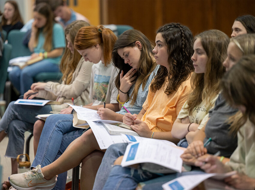 Students take notes at an event April 20, 2024, at Maynard Baptist Church in Forsyth. Ga. (Index/Henry Durand, File)