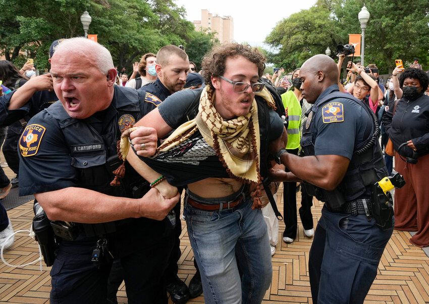 University of Texas police officers arrest a man at a pro-Palestinian protest on campus Wednesday, April 24, 2024, in Austin, Texas. (Jay Janner/Austin American-Statesman via AP)