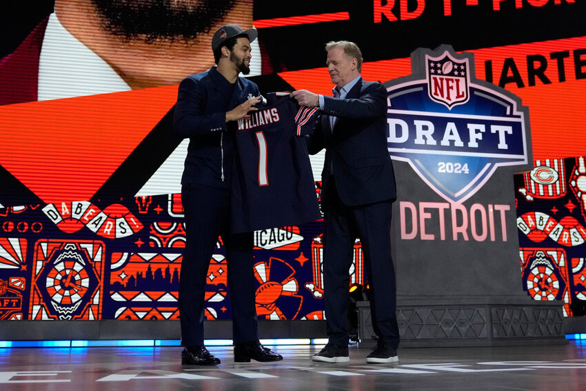 Southern California quarterback Caleb Williams celebrates with NFL commissioner Roger Goodell after being chosen by the Chicago Bears with the first overall pick during the first round of the NFL draft Thursday, April 25, 2024, in Detroit. (AP Photo/Jeff Roberson)