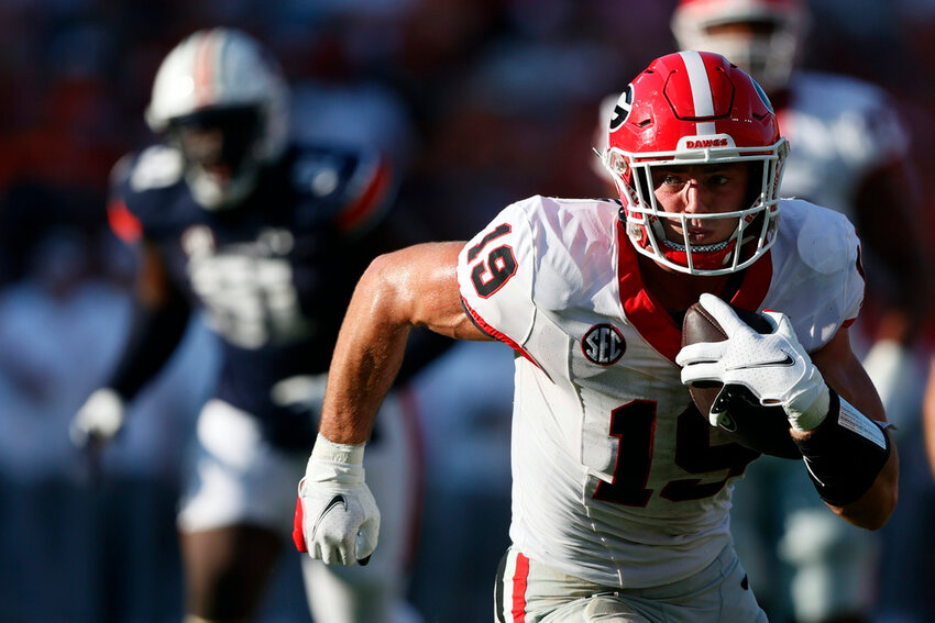Georgia tight end Brock Bowers (19) carries the ball after a reception during the second half against Auburn, Saturday, Sept. 30, 2023, in Auburn, Ala. (AP Photo/Butch Dill, File)