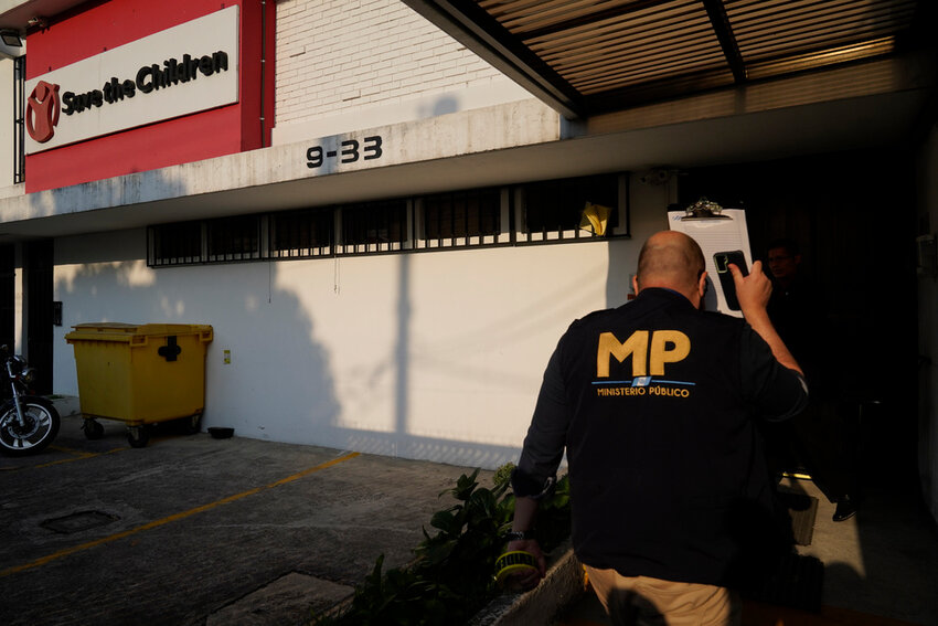 An agent from the Attorney General's office enters Save the Children's headquarters during a raid in Guatemala City, Thursday, April 25, 2024. (AP Photo/Moises Castillo)