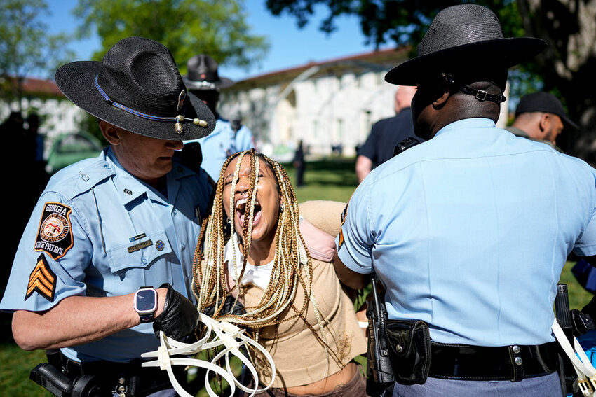 Georgia State Patrol officers detain a demonstrator on the campus of Emory University during a pro-Palestinian demonstration Thursday, April 25, 2024, in Atlanta. (AP Photo/Mike Stewart)
