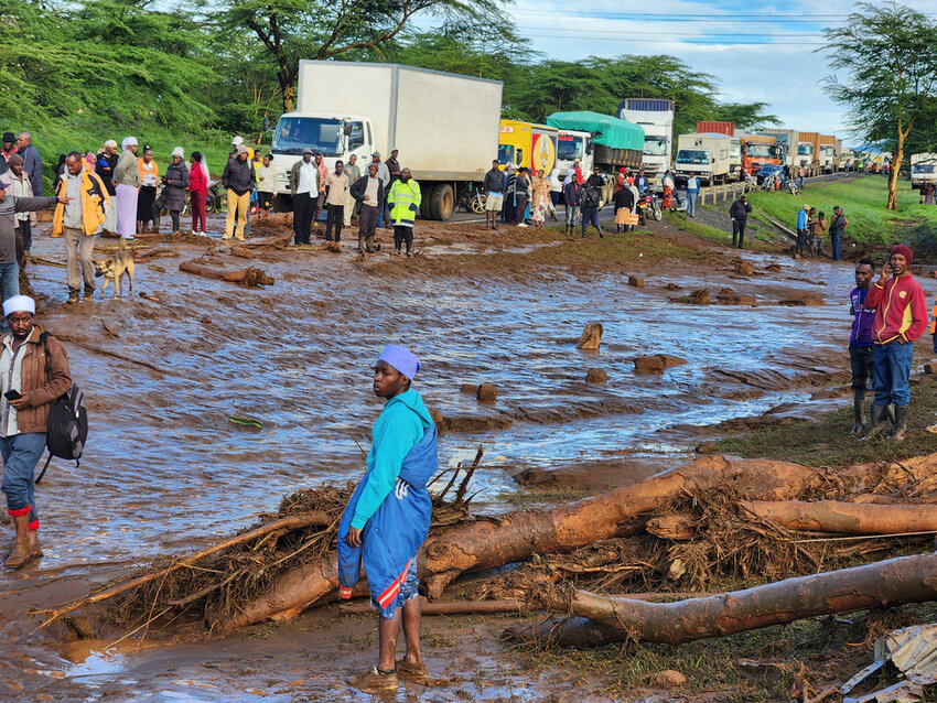 People gather on the main road after a dam burst, in Kamuchiri Village Mai Mahiu, Nakuru County, Kenya, Monday, April 29, 2024.  (AP Photo)