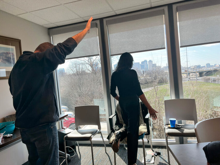Leaders from ministries and churches around Nashville lead the Nashville Diaspora Collective in prayer for their city in their heart languages. The Nashville Baptist Association’s windows overlook the city’s skyline. (Photo/IMB)
