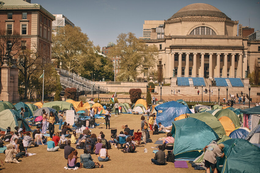 People listen to a speaker at a pro-Palestinian encampment on the campus of Columbia University, Sunday, April 28, 2024, in New York. (AP Photo/Andres Kudacki)