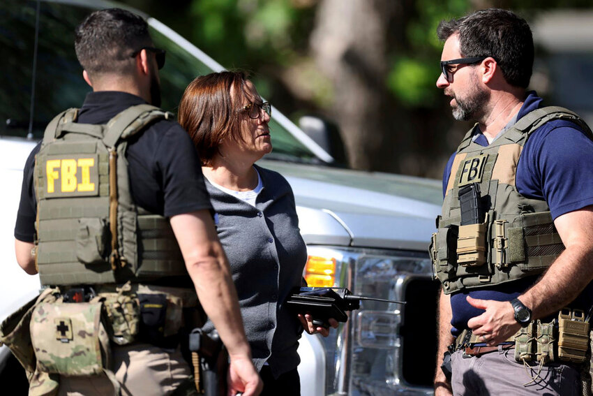 Members of the FBI talk at the scene of a shooting on Galway Drive in Charlotte, N.C., on Monday, April 29, 2024. (Khadejeh Nikouyeh/The Charlotte Observer via AP)