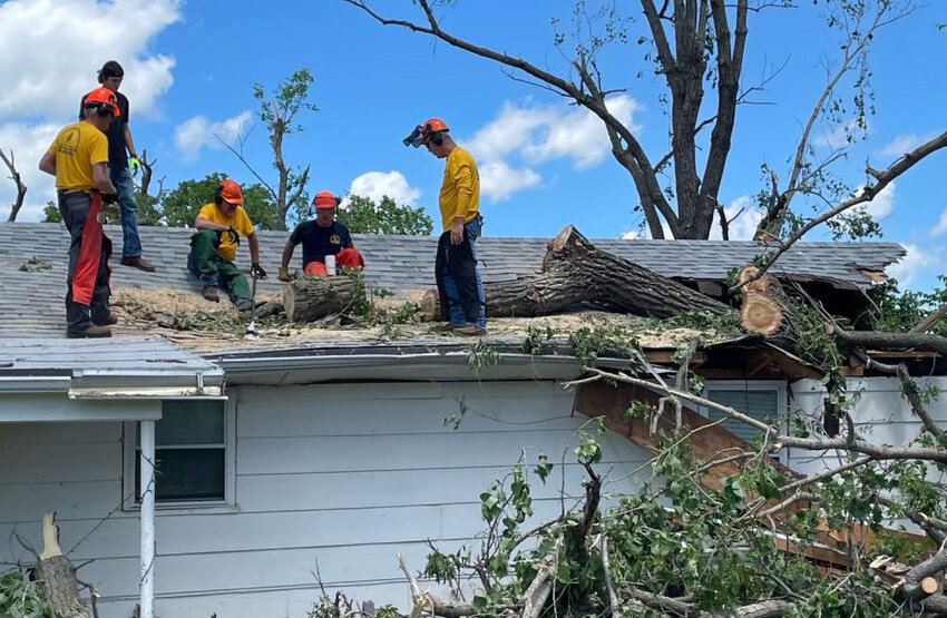 Volunteers with Oklahoma Baptist Disaster Relief clear a fallen tree in the aftermath of tornadoes that hit the state. (Photo/Baptist Messenger)