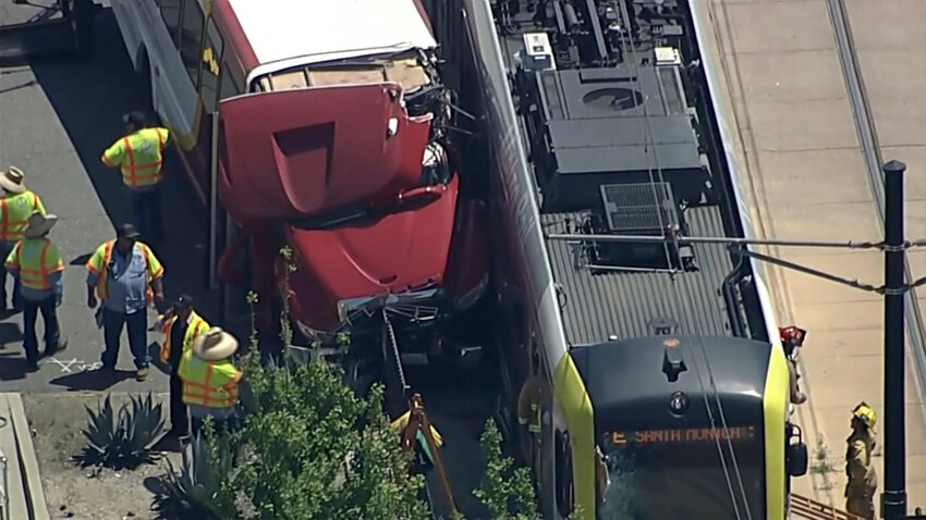 Firefighters respond to the scene of an accident where a shuttle bus collided with a Metro light rail train on Tuesday, April 30, 2024, in Los Angeles. (KABC via AP)