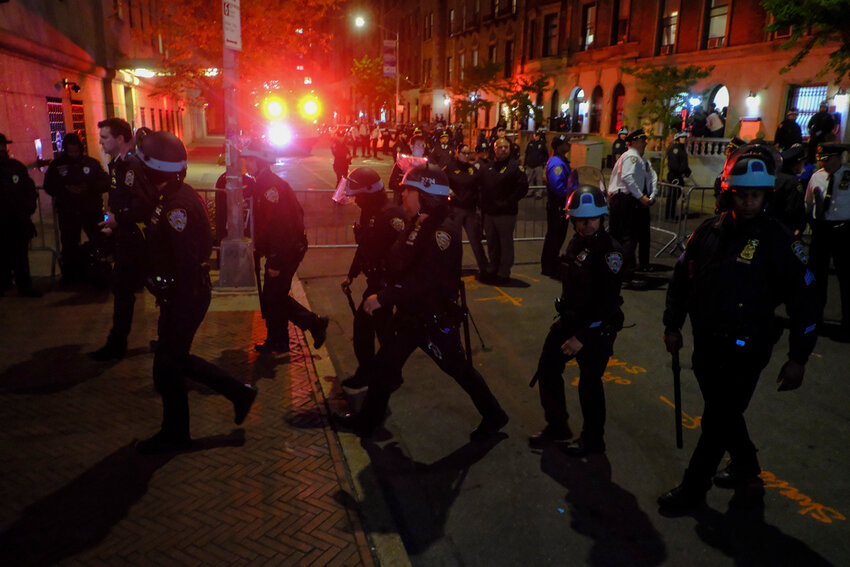 Members of the New York Police Department strategic response team move towards an entrance to Columbia University, Tuesday, April 30, 2024, in New York. (AP Photo/Julius Motal)