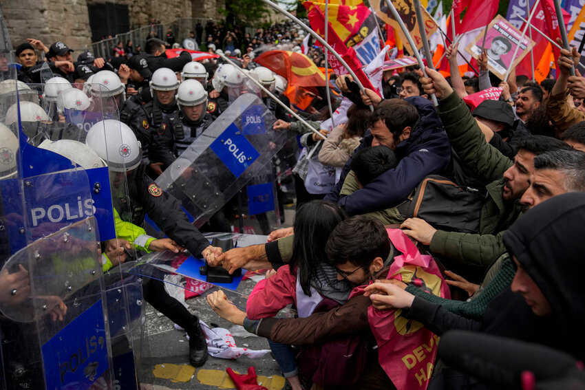 Union members clash with Turkish anti riot police officers as they march during Labor Day celebrations in Istanbul, Turkey, Wednesday, May 1, 2024. (AP Photo/Khalil Hamra)