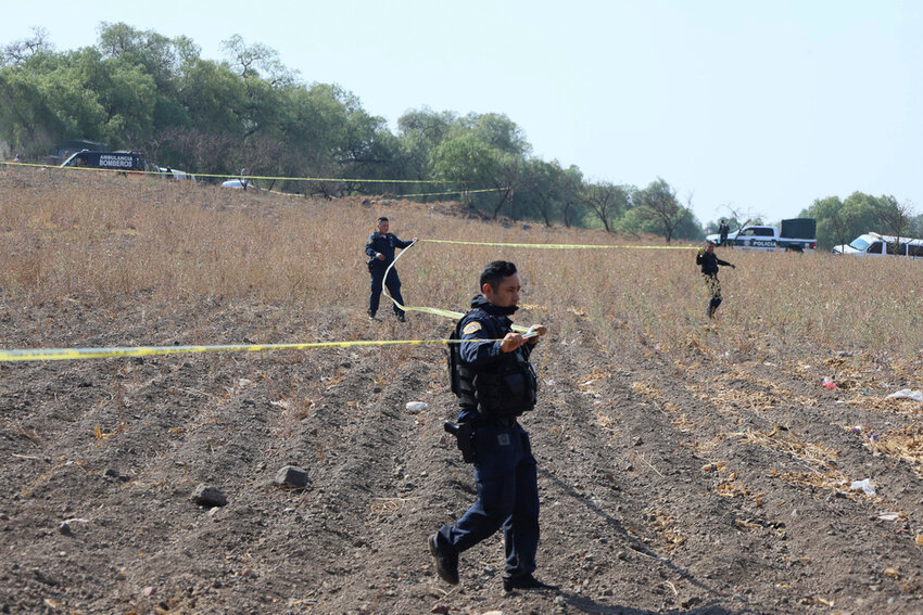 Police tape off the area where volunteers said they have found a clandestine crematorium in Tlahuac, on the edge of Mexico City, Wednesday, May 1, 2024. (AP Photo/Ginnette Riquelme)
