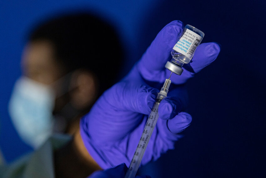 A family nurse practitioner prepares a syringe with the Mpox vaccine for inoculating a patient at a vaccination site in the Brooklyn borough of New York, on Aug. 30, 2022. (AP Photo/Jeenah Moon, File)
