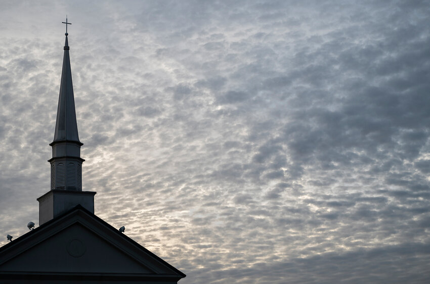 The sun rises behind a cover of clouds at Northside Baptist Church in Tifton, Ga. (Index/Henry Durand, File)