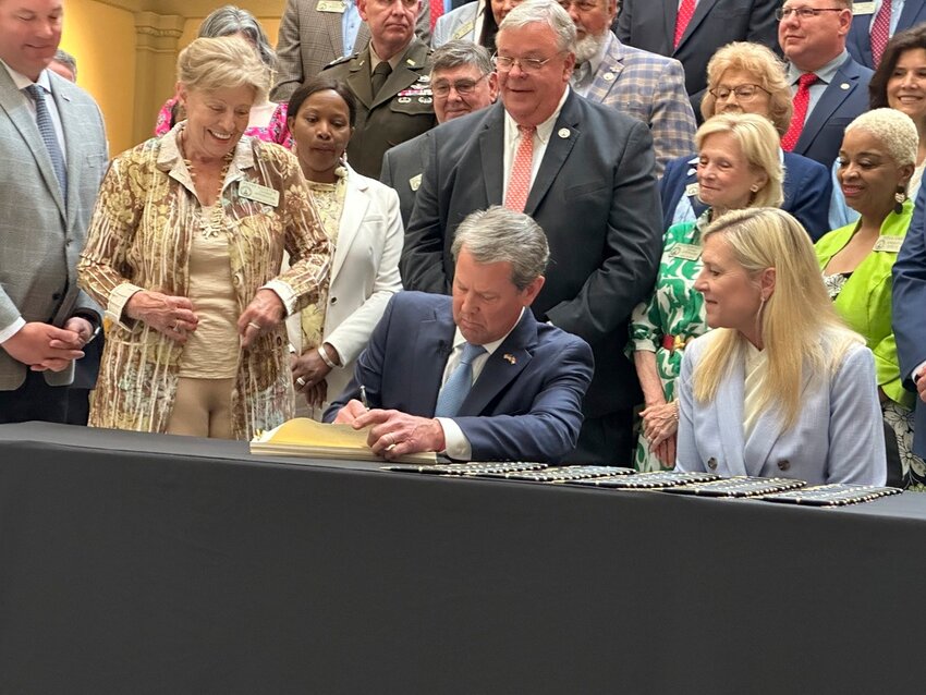 Georgia Gov. Brian Kemp signs the budget for the year beginning July 1, 2024 at the state capitol in Atlanta on Tuesday, May 7, 2024. (AP Photo/Jeff Amy)