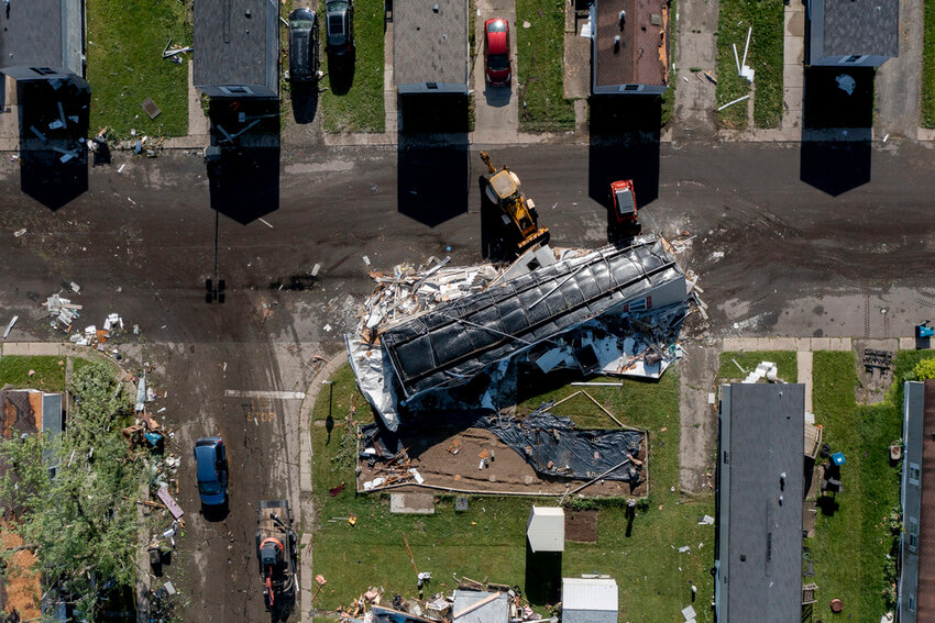 A storm-damaged mobile home rests in the street at Pavilion Estates mobile home park just east of Kalamazoo, Mich. Wednesday, May 8, 2024. (Neil Blake/The Grand Rapids Press via AP)