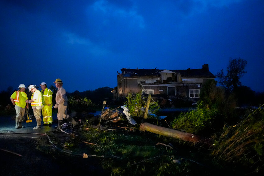 Utility workers survey storm damage in Columbia, Tenn., Wednesday, May 8, 2024. (AP Photo/George Walker IV)
